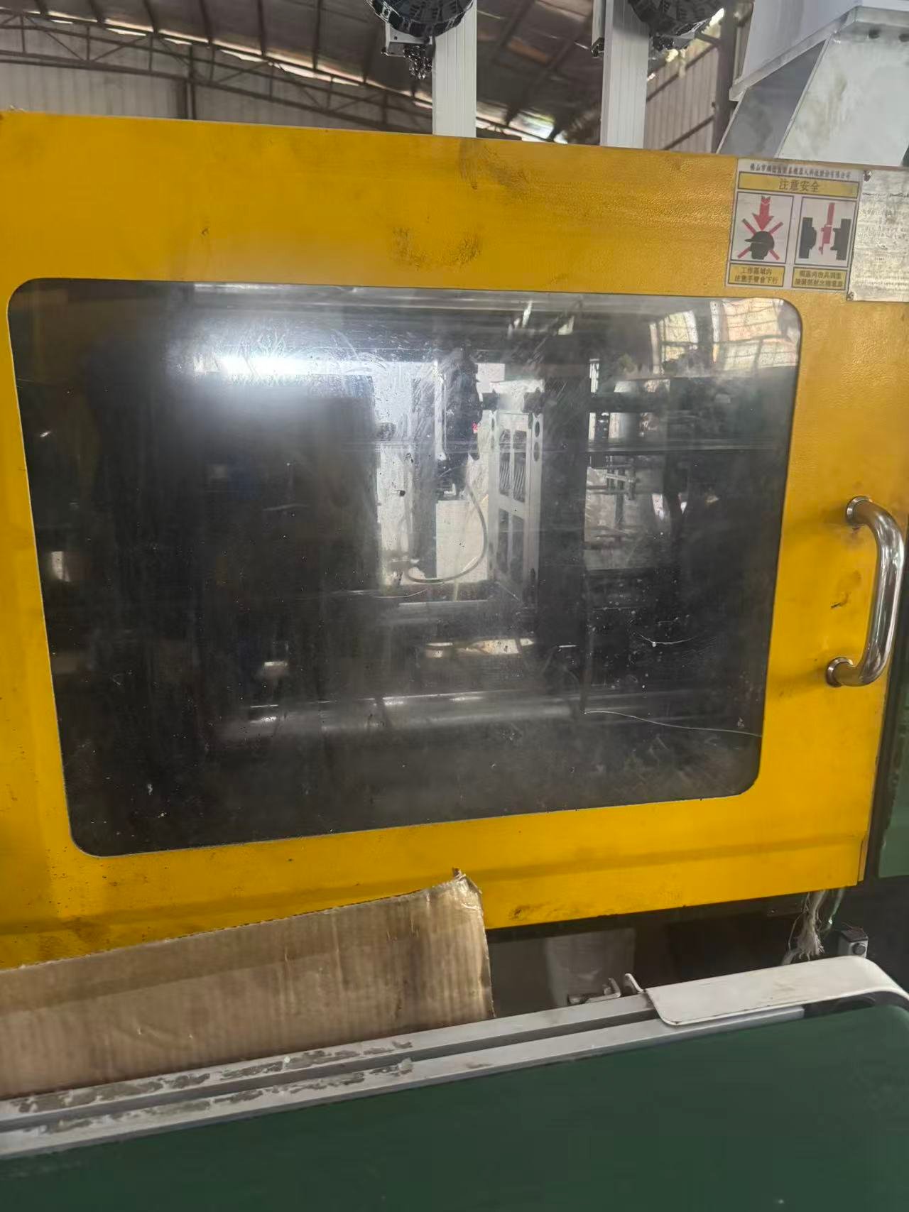 Injection molding machine during PC+ABS enclosure production
